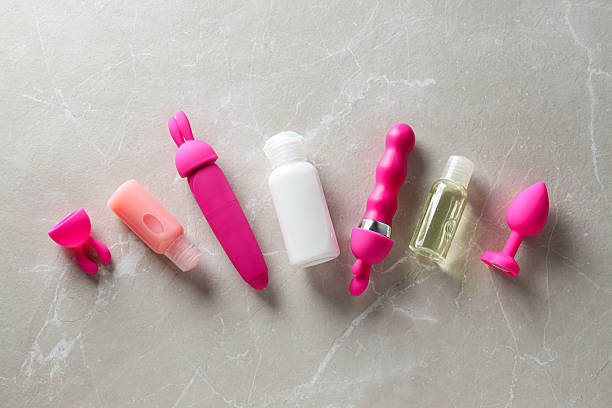Lubricant in a white bottle and toys for sex